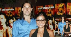 Antonimar Mello and companion at movie premiere event with promotional posters in background