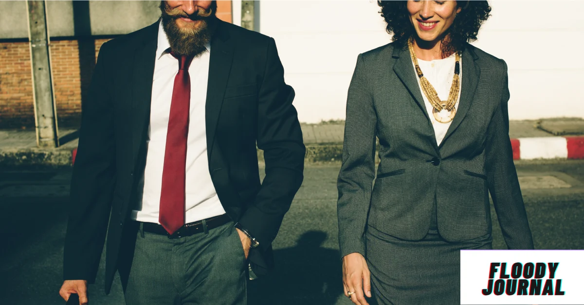 Best outfit ideas for work meetings professional man in navy suit red tie and woman in gray blazer walking together