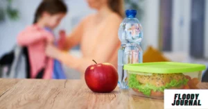 How to make healthy school lunch with red apple water bottle and sandwich in green container with children in background