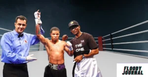 Demetris Fenwick celebrates boxing victory with referee and corner man in professional boxing ring